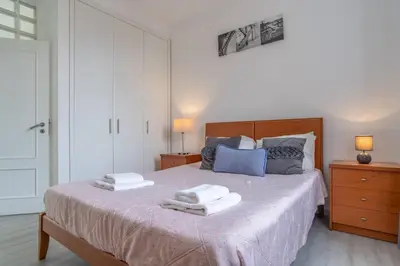 a bedroom with a bed with two towels on it at Duas Torres View Apartment in Funchal