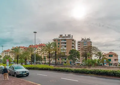 a room with a table and chairs and a large window at Duas Torres View Apartment in Funchal