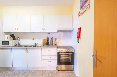 a kitchen with white cabinets and a stove top oven at Santana House Holiday Rental - For Nature Lovers by YOUR KEY in Santana