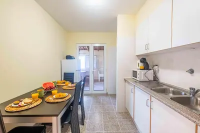 a kitchen with a table with plates of food on it at Santana House Holiday Rental - For Nature Lovers by YOUR KEY in Santana