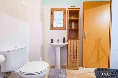 a bathroom with a toilet and a sink at Santana House Holiday Rental - For Nature Lovers by YOUR KEY in Santana