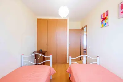 a bedroom with two beds and a closet at Santana House Holiday Rental - For Nature Lovers by YOUR KEY in Santana