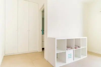 a white room with white cabinets and a wall at Casa Hortas in Vila do Bispo