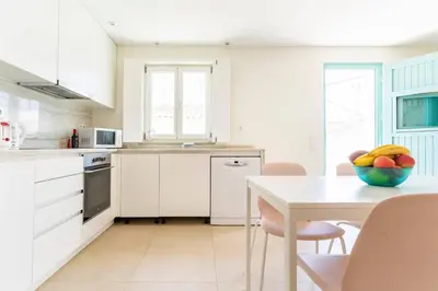 a kitchen with a table with a bowl of fruit on it at Casa Hortas in Vila do Bispo