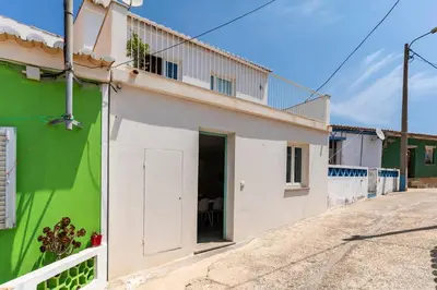 a building with a green and white facade at Casa Hortas in Vila do Bispo