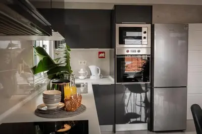 a kitchen with a stainless steel refrigerator at Achada Sol in Funchal