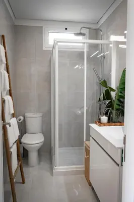 a bathroom with a toilet and a glass shower at Achada Sol in Funchal