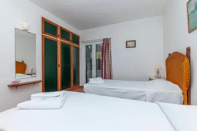 a bedroom with two beds and a window at Casas da Calheta in Praia da Luz in Luz