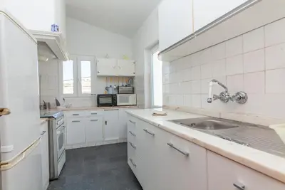 a kitchen with white cabinets and a sink at Casas da Calheta in Praia da Luz in Luz
