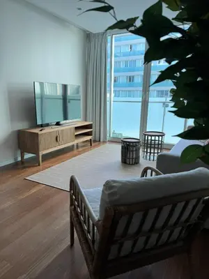 a living room with a couch and a television at Plaza Funchal - Coração da cidade in Funchal