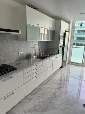 a kitchen with white cabinets and stainless steel appliances at Plaza Funchal - Coração da cidade in Funchal