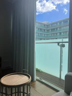 a room with a table and a large window at Plaza Funchal - Coração da cidade in Funchal
