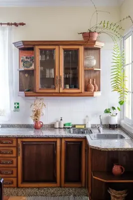 a kitchen with wooden cabinets and a sink at GuestReady - Tranquil Spot in São Vicente in São Vicente