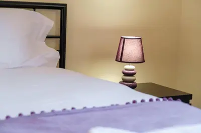 a bedroom with a bed and a lamp on a table at GuestReady - Tranquil Spot in São Vicente in São Vicente
