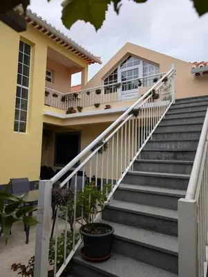 a house with stairs in front of it at GuestReady - Tranquil Spot in São Vicente in São Vicente