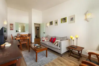 a living room with a couch and a table at B86 - Beachline Apartment in Praia da Luz in Luz