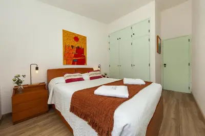 a bedroom with a large bed with two towels on it at B86 - Beachline Apartment in Praia da Luz in Luz
