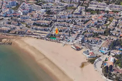 an aerial view of a beach with a red kite at B86 - Beachline Apartment in Praia da Luz in Luz