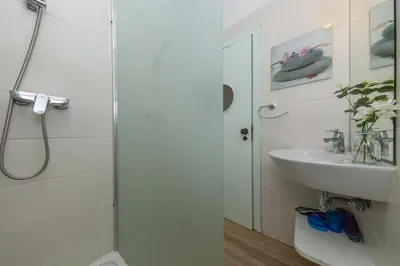 a bathroom with a sink and a toilet and a shower at B86 - Beachline Apartment in Praia da Luz in Luz