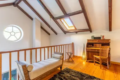 a living room with a couch and a piano at Villa Tabua in Ribeira Brava