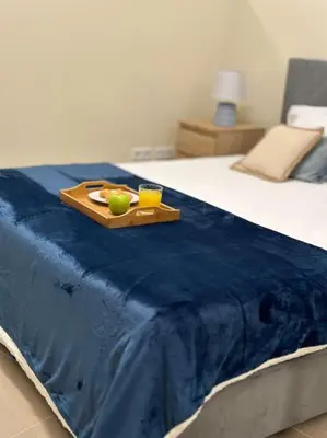 a tray with a bowl of fruit on a bed at Olá Mar in Santa Cruz