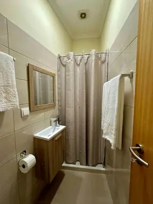 a bathroom with a shower curtain and a sink at Olá Mar in Santa Cruz