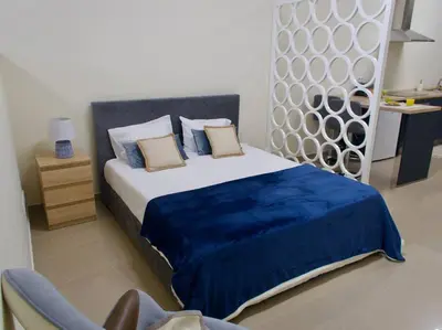 a bedroom with a large bed with a blue blanket at Olá Mar in Santa Cruz