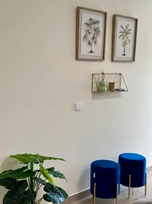 a room with two blue chairs and a plant at Olá Mar in Santa Cruz