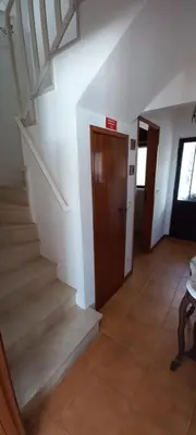 a hallway with stairs and a door in a building at Casa do Mar in Salema