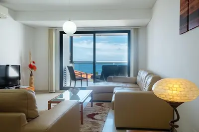 a living room with a couch and a large window at GuestReady - A splendid sea-view stay in Caniço