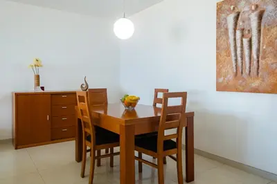 a dining room table with chairs and a bowl of fruit on it at GuestReady - A splendid sea-view stay in Caniço