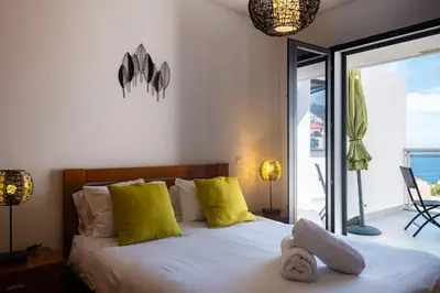 a bedroom with a bed with yellow pillows and a window at GuestReady - A splendid sea-view stay in Caniço