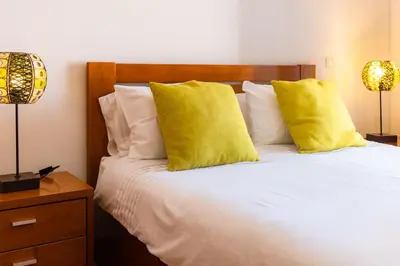 a bedroom with a bed with two yellow pillows at GuestReady - A splendid sea-view stay in Caniço