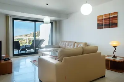 a living room with a couch and a table at GuestReady - A splendid sea-view stay in Caniço