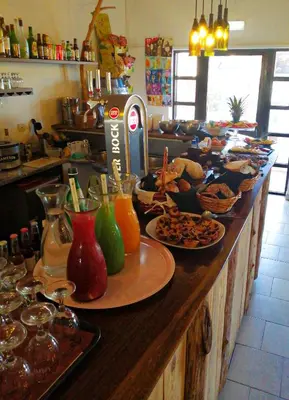a counter with many plates of food on it at CASA DA HORTA in Aljezur