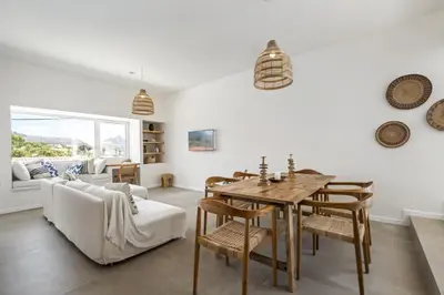 a living room with a table and a couch at Casa do Cacto - By WeHost in Porto Santo
