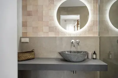 a bathroom with a bowl sink and a mirror at Casa do Cacto - By WeHost in Porto Santo