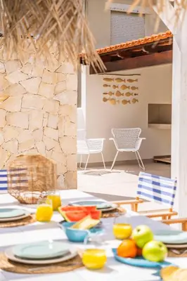 a table with plates of fruit on top of it at Casa do Cacto - By WeHost in Porto Santo