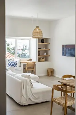 a living room with a white couch and a table at Casa do Cacto - By WeHost in Porto Santo