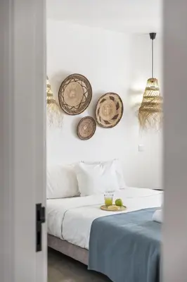 a bedroom with a bed with three baskets on the wall at Casa do Cacto - By WeHost in Porto Santo