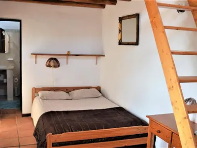 a bedroom with a bed in a room at Monte Rosa Rural Guesthouse in Lagos