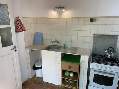 a small kitchen with a sink and a stove at Monte Rosa Rural Guesthouse in Lagos