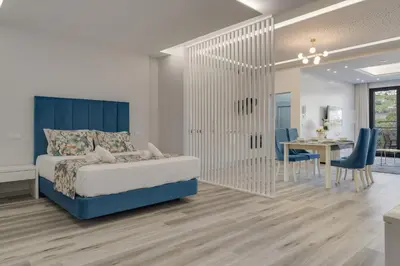 a bedroom with a bed and a dining room at Torre Palace I by Atlantic Holiday in Câmara de Lobos