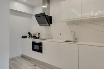 a white kitchen with a sink and a microwave at Torre Palace II by Atlantic Holiday in Câmara de Lobos