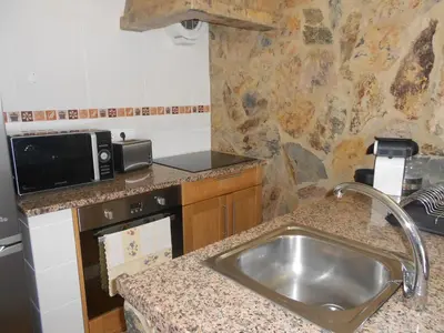 a small kitchen with a sink and a microwave at Monte Chabouco - Alojamento Local in Chabouco