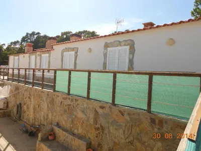 a fence on the side of a building at Monte Chabouco - Alojamento Local in Chabouco