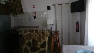a kitchen with a giraffe patterned counter and a stool at Monte Chabouco - Alojamento Local in Chabouco