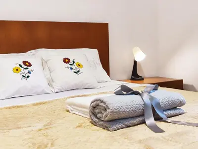 a bedroom with a bed with two pillows and a blanket at GATEONE AL Airport View House in Machico