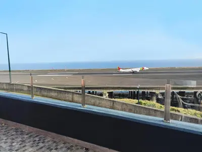 an airplane is on the runway at an airport at GATEONE AL Airport View House in Machico