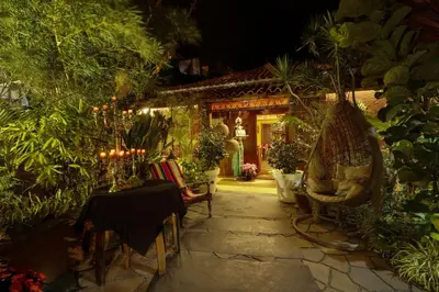 a patio with a table and chairs in front of a house at Dazkarizeh73 in Ribeira Brava